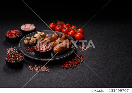 Grilled chicken or beef sausages with sauce and spices. Grilled sausages 133499707