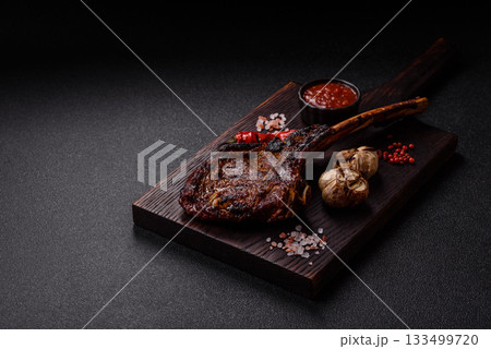Grilled bone-in meat, beef tomahawk steak, juicy barbecued meat. Tomahawk steak 133499720