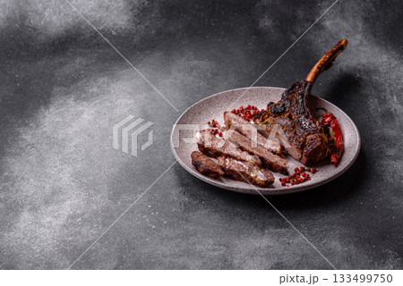 Grilled bone-in meat, beef tomahawk steak, juicy barbecued meat. Tomahawk steak 133499750