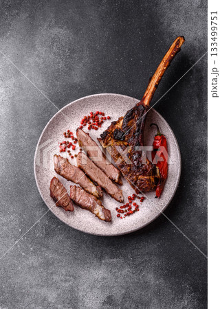 Grilled bone-in meat, beef tomahawk steak, juicy barbecued meat. Tomahawk steak 133499751
