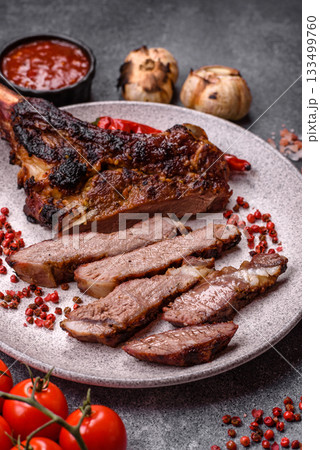 Grilled bone-in meat, beef tomahawk steak, juicy barbecued meat. Tomahawk steak 133499760