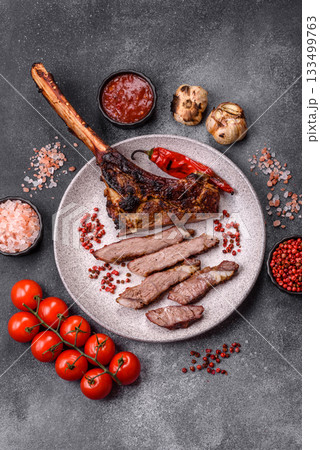 Grilled bone-in meat, beef tomahawk steak, juicy barbecued meat. Tomahawk steak 133499763