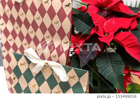 Colorful Christmas presents with decorative poinsettia 133499816