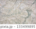 Intricate swirls and patterns of natural stone create a unique textured surface 133499895