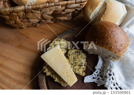Top of basket with wholemeal breads and cheese, presenting a healthy and traditional breakfast or brunch Top of basket with wholemeal breads and cheese, presenting a healthy and traditional breakfast or brunch 133500901