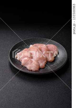 Slices of raw chicken or turkey breast, skinless and boneless. Chicken breast slices Slices of raw chicken or turkey breast, skinless and boneless. Chicken breast slices 133500963