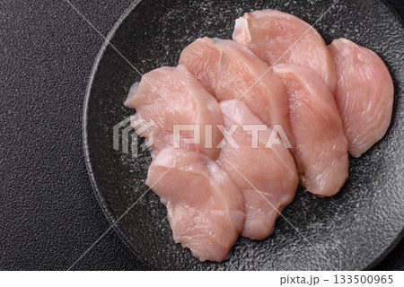 Slices of raw chicken or turkey breast, skinless and boneless. Chicken breast slices Slices of raw chicken or turkey breast, skinless and boneless. Chicken breast slices 133500965