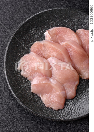 Slices of raw chicken or turkey breast, skinless and boneless. Chicken breast slices Slices of raw chicken or turkey breast, skinless and boneless. Chicken breast slices 133500966