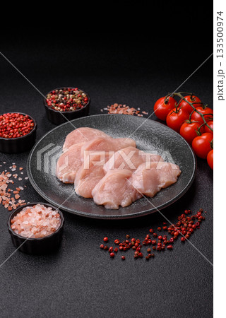 Slices of raw chicken or turkey breast, skinless and boneless. Chicken breast slices 133500974