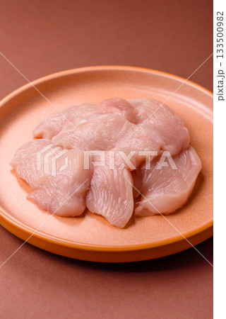 Slices of raw chicken or turkey breast, skinless and boneless. Chicken breast slices 133500982