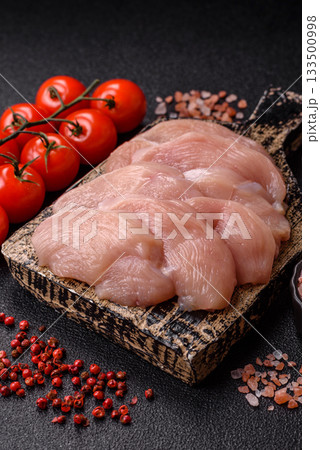 Slices of raw chicken or turkey breast, skinless and boneless. Chicken breast slices Slices of raw chicken or turkey breast, skinless and boneless. Chicken breast slices 133500998