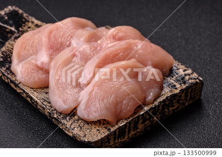 Slices of raw chicken or turkey breast, skinless and boneless. Chicken breast slices Slices of raw chicken or turkey breast, skinless and boneless. Chicken breast slices 133500999