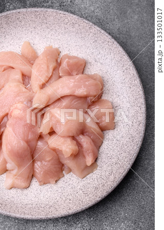 Strips of raw chicken or turkey fillet, skinless and boneless poultry breast. Chicken fillet strips Strips of raw chicken or turkey fillet, skinless and boneless poultry breast. Chicken fillet strips 133501017