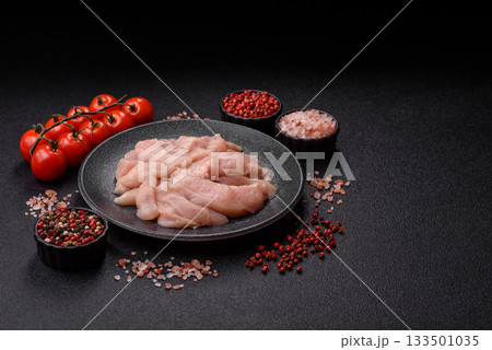 Strips of raw chicken or turkey fillet, skinless and boneless poultry breast. Chicken fillet strips Strips of raw chicken or turkey fillet, skinless and boneless poultry breast. Chicken fillet strips 133501035