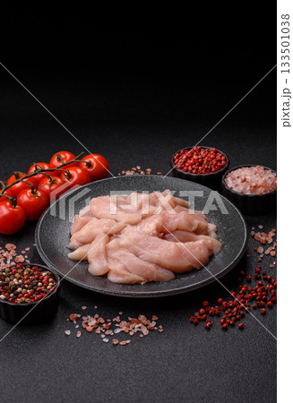 Strips of raw chicken or turkey fillet, skinless and boneless poultry breast. Chicken fillet strips Strips of raw chicken or turkey fillet, skinless and boneless poultry breast. Chicken fillet strips 133501038