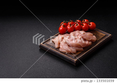 Strips of raw chicken or turkey fillet, skinless and boneless poultry breast. Chicken fillet strips Strips of raw chicken or turkey fillet, skinless and boneless poultry breast. Chicken fillet strips 133501039