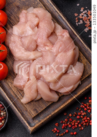 Strips of raw chicken or turkey fillet, skinless and boneless poultry breast. Chicken fillet strips Strips of raw chicken or turkey fillet, skinless and boneless poultry breast. Chicken fillet strips 133501049