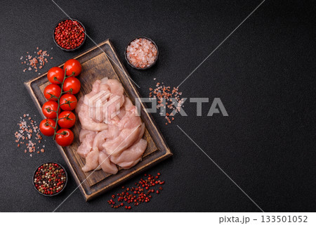 Strips of raw chicken or turkey fillet, skinless and boneless poultry breast. Chicken fillet strips Strips of raw chicken or turkey fillet, skinless and boneless poultry breast. Chicken fillet strips 133501052