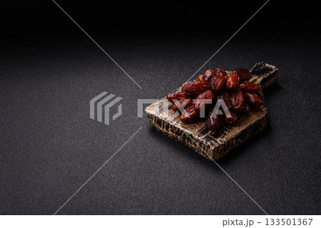 Dried dates in a ceramic plate, arabic food for the ramadan table. Dried dates as a background 133501367