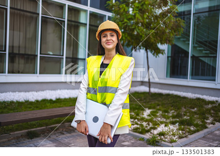 Smiling female safety engineer outdoors Smiling female safety engineer outdoors 133501383