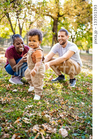 Joyful family moments in a sunny park during autumn 133501393