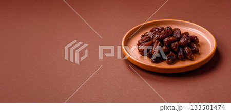 Dried dates in a ceramic plate, arabic food for the ramadan table. Dried dates as a food backgrounds 133501474