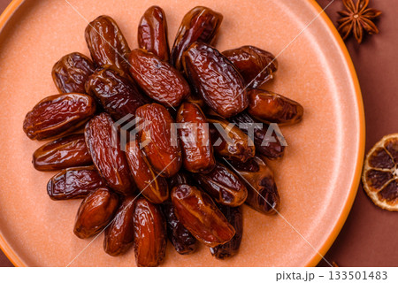 Dried dates in a ceramic plate, arabic food for the ramadan table. Dried dates as a food backgrounds 133501483