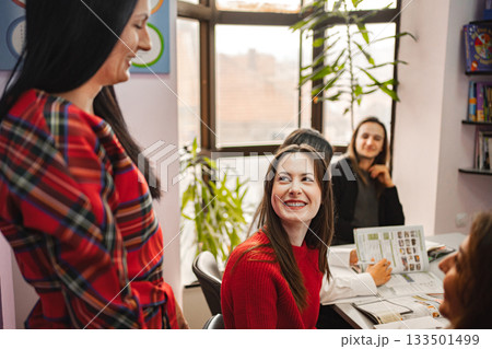 Female teacher explaining subject to her teenage students at language school Female teacher explaining subject to her teenage students at language school 133501499
