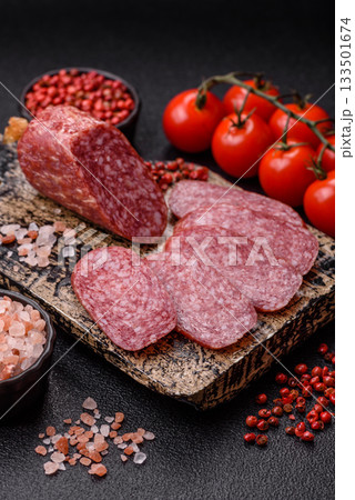 Sliced salami sausage, smoked meat as a delicacy for the table. Salami sausage Sliced salami sausage, smoked meat as a delicacy for the table. Salami sausage 133501674