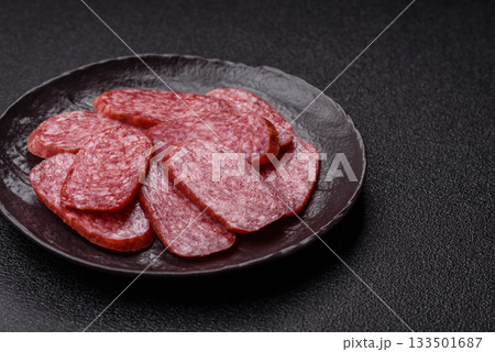 Sliced salami sausage, smoked meat as a delicacy for the table. Salami sausage Sliced salami sausage, smoked meat as a delicacy for the table. Salami sausage 133501687