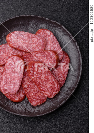 Sliced salami sausage, smoked meat as a delicacy for the table. Salami sausage Sliced salami sausage, smoked meat as a delicacy for the table. Salami sausage 133501689