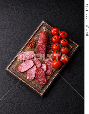 Sliced salami sausage, smoked meat as a delicacy for the table. Salami sausage Sliced salami sausage, smoked meat as a delicacy for the table. Salami sausage 133501713