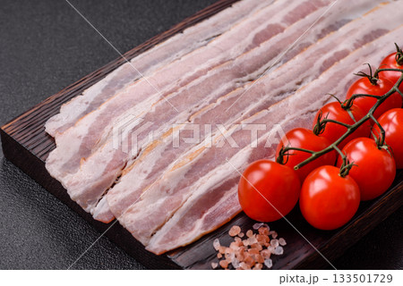 Raw or smoked pork bacon slices or strips as a breakfast ingredient. Raw bacon 133501729
