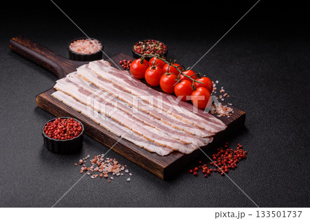 Raw or smoked pork bacon slices or strips as a breakfast ingredient. Raw bacon 133501737
