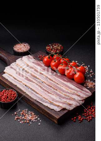 Raw or smoked pork bacon slices or strips as a breakfast ingredient. Raw bacon 133501739