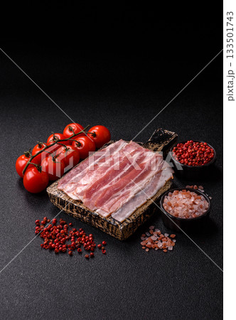 Raw or smoked pork bacon slices or strips as a breakfast ingredient. Raw bacon 133501743