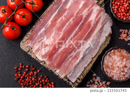 Raw or smoked pork bacon slices or strips as a breakfast ingredient. Raw bacon 133501745
