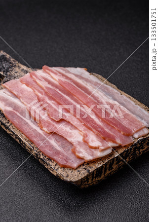 Raw or smoked pork bacon slices or strips as a breakfast ingredient. Raw bacon 133501751