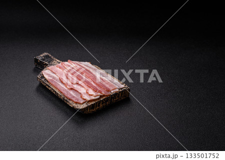 Raw or smoked pork bacon slices or strips as a breakfast ingredient. Raw bacon 133501752