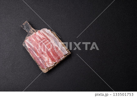 Raw or smoked pork bacon slices or strips as a breakfast ingredient. Raw bacon 133501753