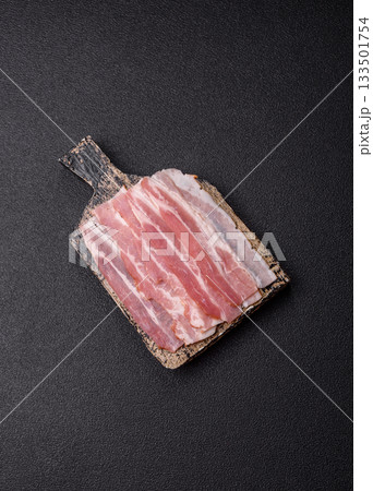 Raw or smoked pork bacon slices or strips as a breakfast ingredient. Raw bacon 133501754