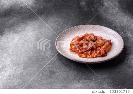 Fried pork bacon slices or strips as a breakfast ingredient. Fried bacon 133501756