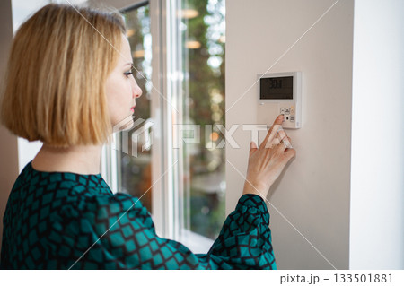 Woman Turning On Light Switch Woman Turning On Light Switch 133501881