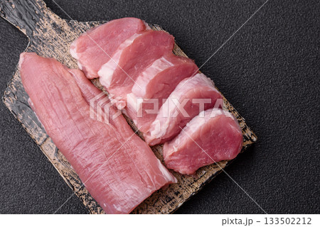 Raw pork tenderloin, sliced, is fresh meat, a source of protein. Pork tenderloin 133502212