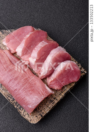 Raw pork tenderloin, sliced, is fresh meat, a source of protein. Pork tenderloin Raw pork tenderloin, sliced, is fresh meat, a source of protein. Pork tenderloin 133502213