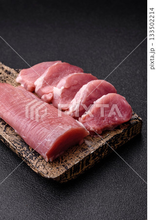 Raw pork tenderloin, sliced, is fresh meat, a source of protein. Pork tenderloin 133502214