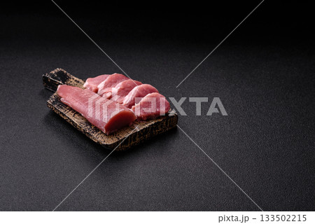 Raw pork tenderloin, sliced, is fresh meat, a source of protein. Pork tenderloin 133502215