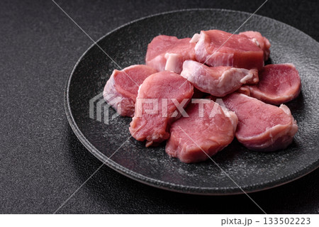 Raw pork tenderloin, sliced, is fresh meat, a source of protein. Pork tenderloin Raw pork tenderloin, sliced, is fresh meat, a source of protein. Pork tenderloin 133502223
