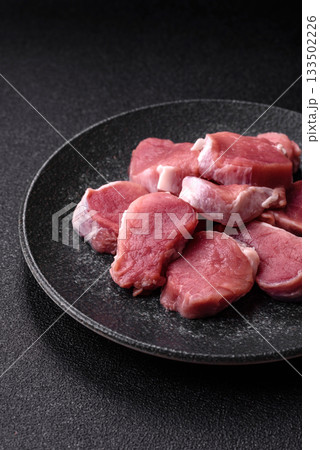 Raw pork tenderloin, sliced, is fresh meat, a source of protein. Pork tenderloin 133502226