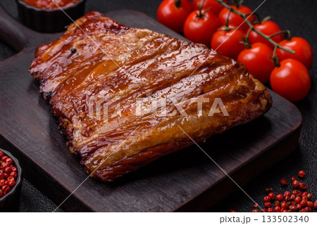 Grilled or barbecued pork or beef ribs with sauce. Cooked or smoked ribs Grilled or barbecued pork or beef ribs with sauce. Cooked or smoked ribs 133502340